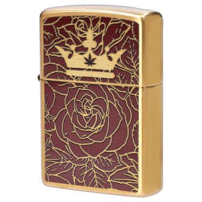 Close-up angled view of the Queen of Bud: Passion Ritual Box – Candle, Zippo, and Crystal showing a gold Zippo with engraved crown and rose pattern on a textured burgundy background.