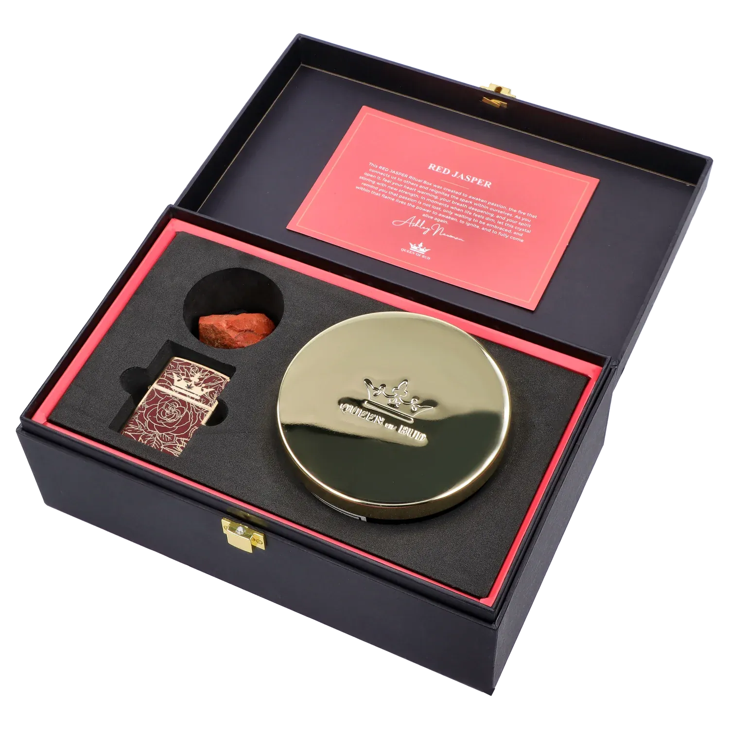 Angled top-down view of the Queen of Bud: Passion Ritual Box – Candle, Zippo, and Crystal inside a black box with red card, gold round candle tin, patterned Zippo, and red jasper stone