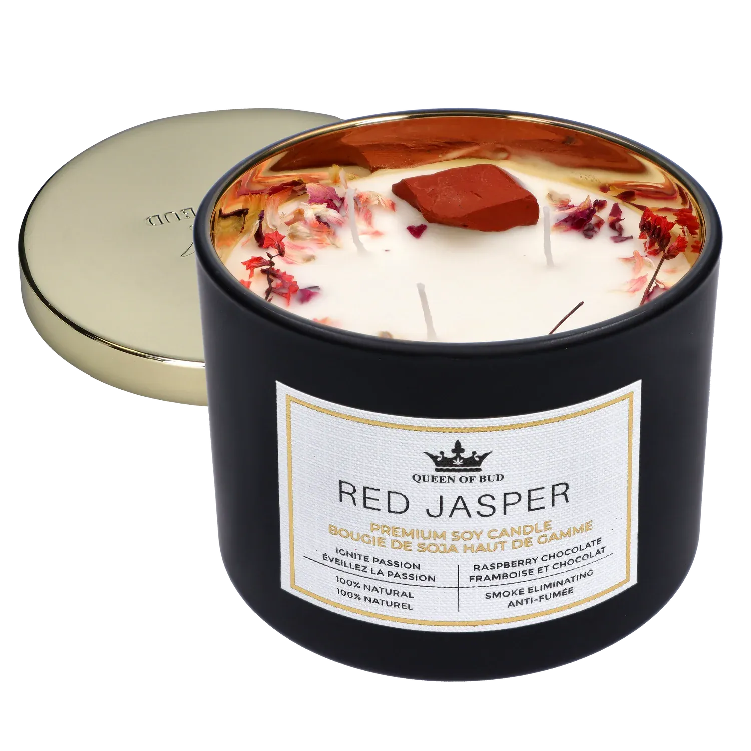 Angled close-up of the Queen of Bud: Passion Ritual Box – Candle, Zippo, and Crystal showing a black tin candle with white wax, dried rose petals and a red jasper stone inside, and a gold lid set behind.