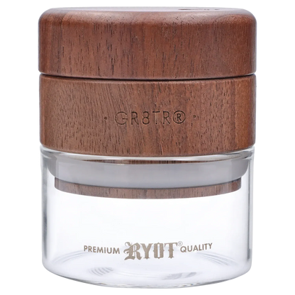 Close-up front view of the RYOT - GR8TR Walnut Wood Top Grinder w/ Clear Glass Jar Body - 3 inch showing the textured walnut top engraved “GR8TR” above the clear glass jar.