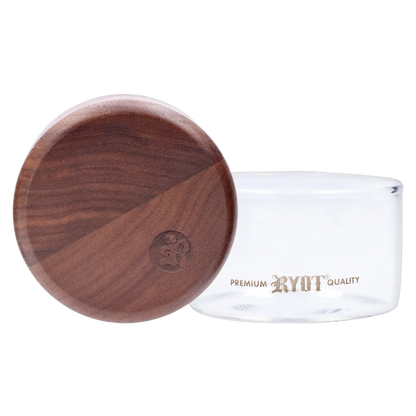 Close-up front view of the RYOT - GR8TR Walnut Wood Top Grinder w/ Clear Glass Jar Body - 3 inch showing the round walnut lid with branded stamp resting against the clear glass jar.