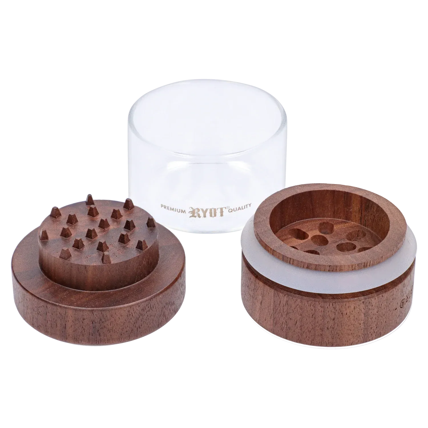 Close-up, top-down view of the disassembled RYOT - GR8TR Walnut Wood Top Grinder w/ Clear Glass Jar Body - 3 inch showing two walnut wooden halves with teeth and a clear glass jar labeled RYOT behind them.