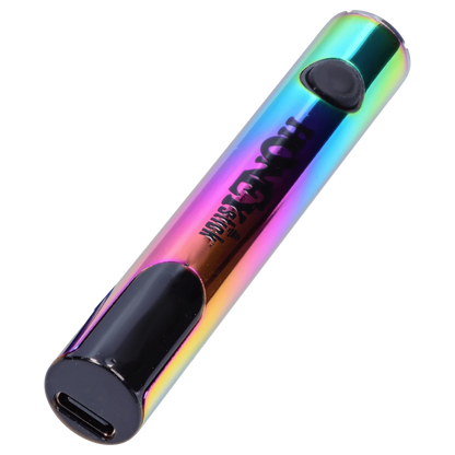 Angled close-up of the iridescent HoneyStick Digital Battery - Multi Carton showing its rounded USB-C base, black button, and reflective rainbow finish