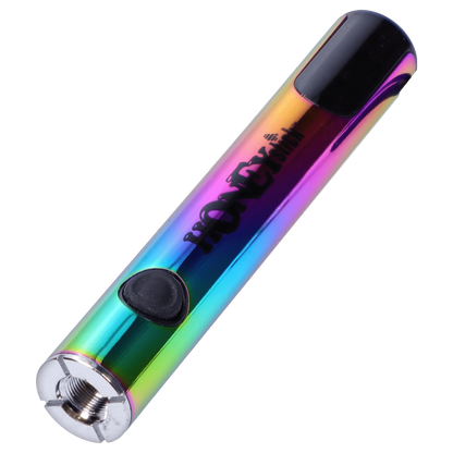 Angled close-up of a rainbow-metal HoneyStick Digital Battery - Multi Carton showing its black mouthpiece, activation button, and threaded metal base.
