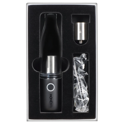 Top-down view of the HNY HoneyStick Lil Ripper in black nestled in foam packaging alongside a metal cartridge and wrapped accessories.