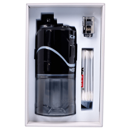 A front view of the black Yocan iCan Kit, presented open in its box with accessories arranged to the side.