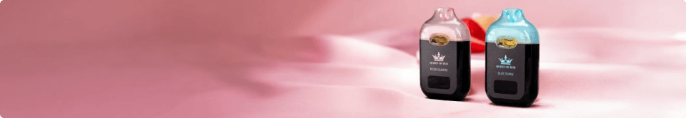 Two QOB disposable vape pods with pink and blue translucent tops labeled "QOB" on a soft pink background
